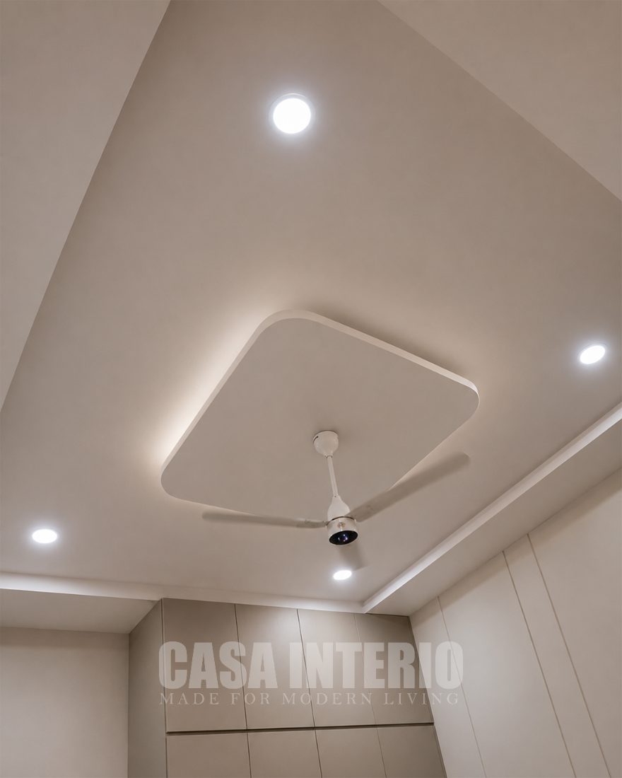 Square tray ceiling with cove lighting above a fan