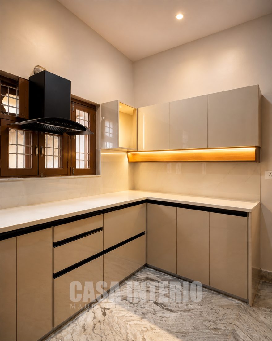 Champagne modular kitchen with black chimney and under-cabinet light