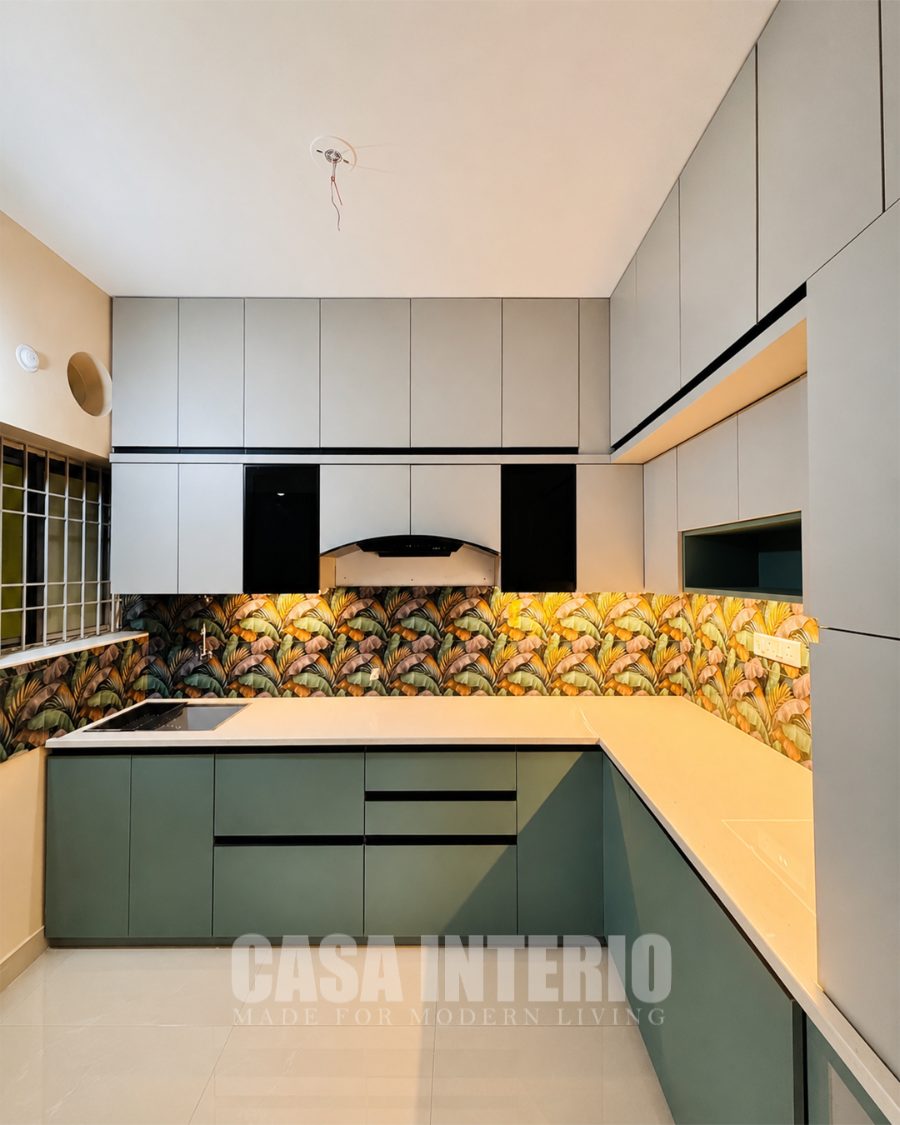 Modular kitchen with sage cabinetry and patterned backsplash